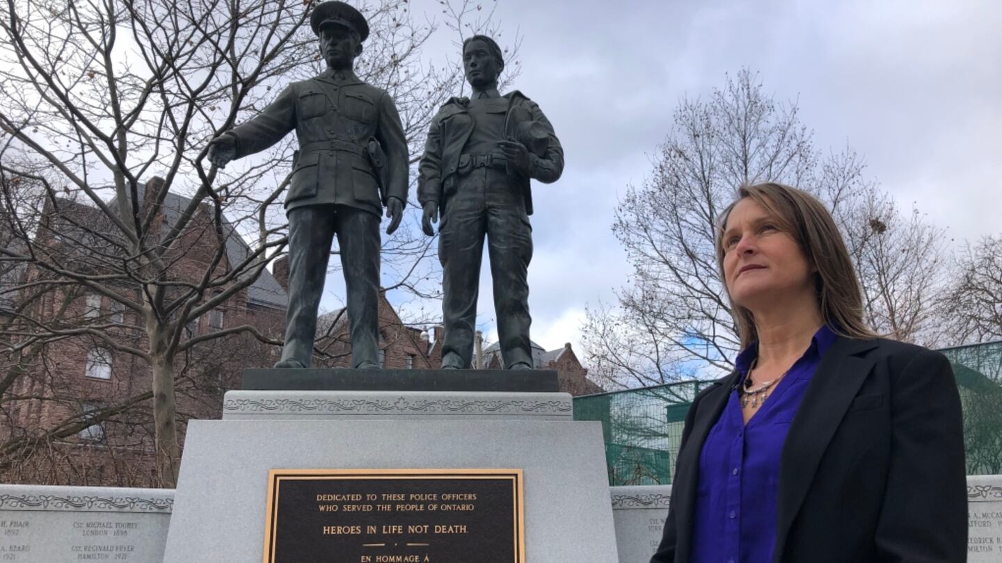 Michelle Vincent standing at a police officers\u2019 memorial, interviewed by CTV News Toronto